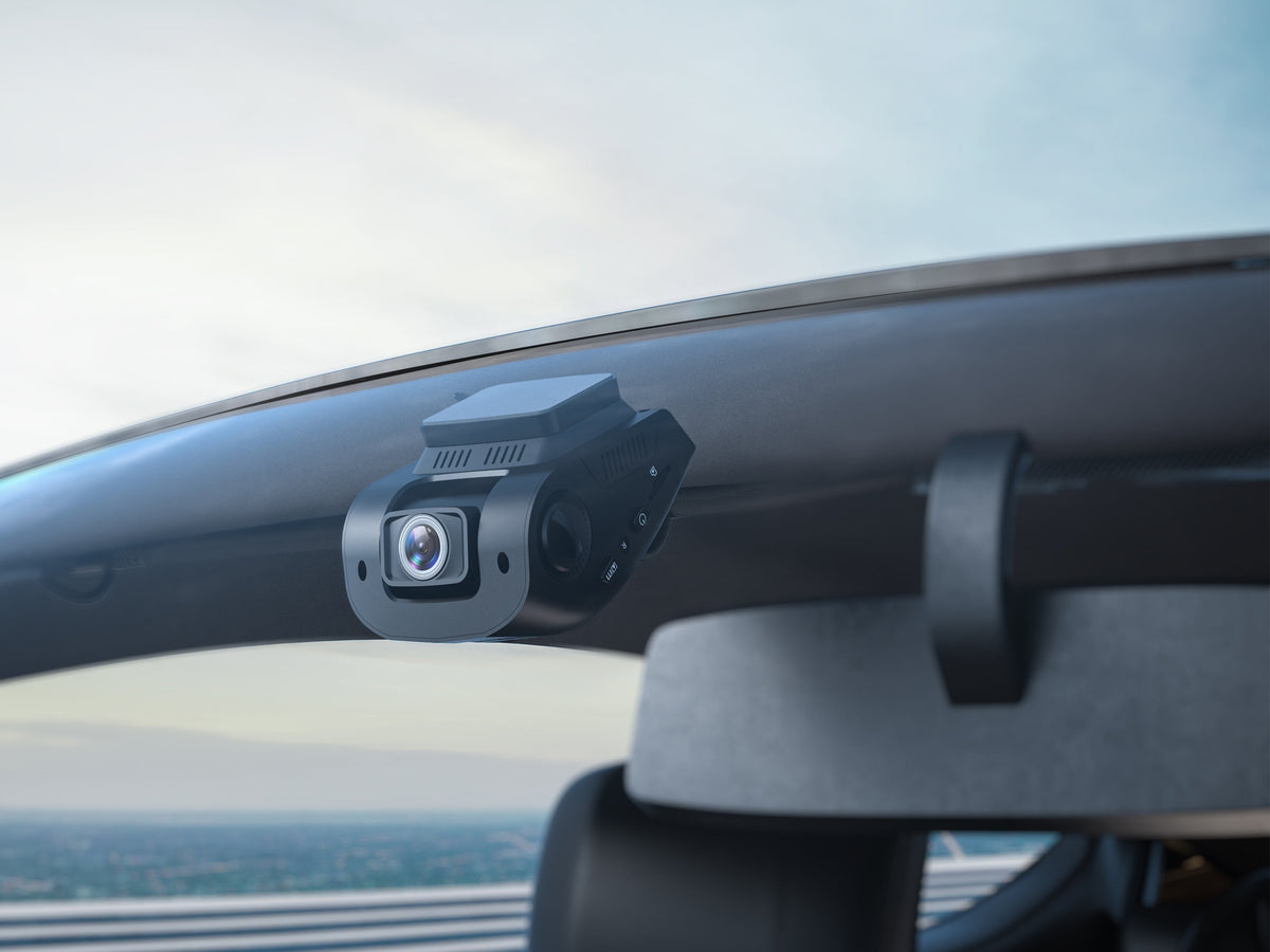 Rexing dash cam mounted on a windshield with a clear view ahead